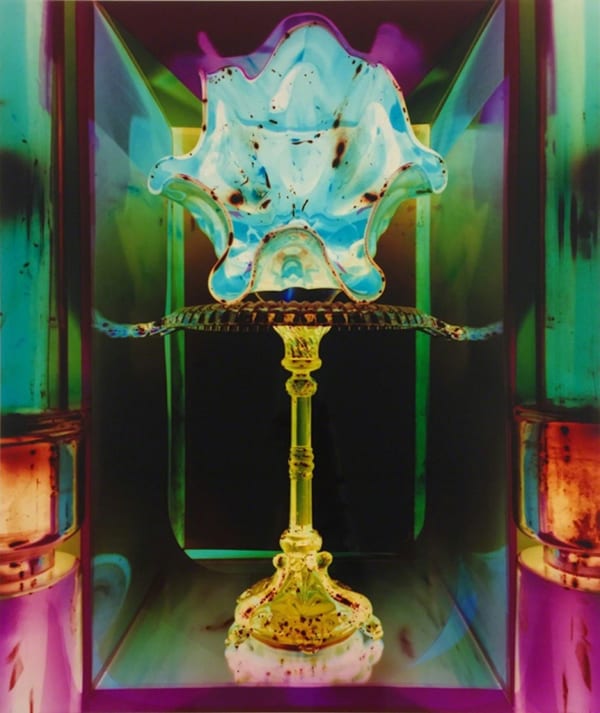 Still life created out of stacked depression glass. Image Because the image is shown in the negative it creates a jewel toned color print.